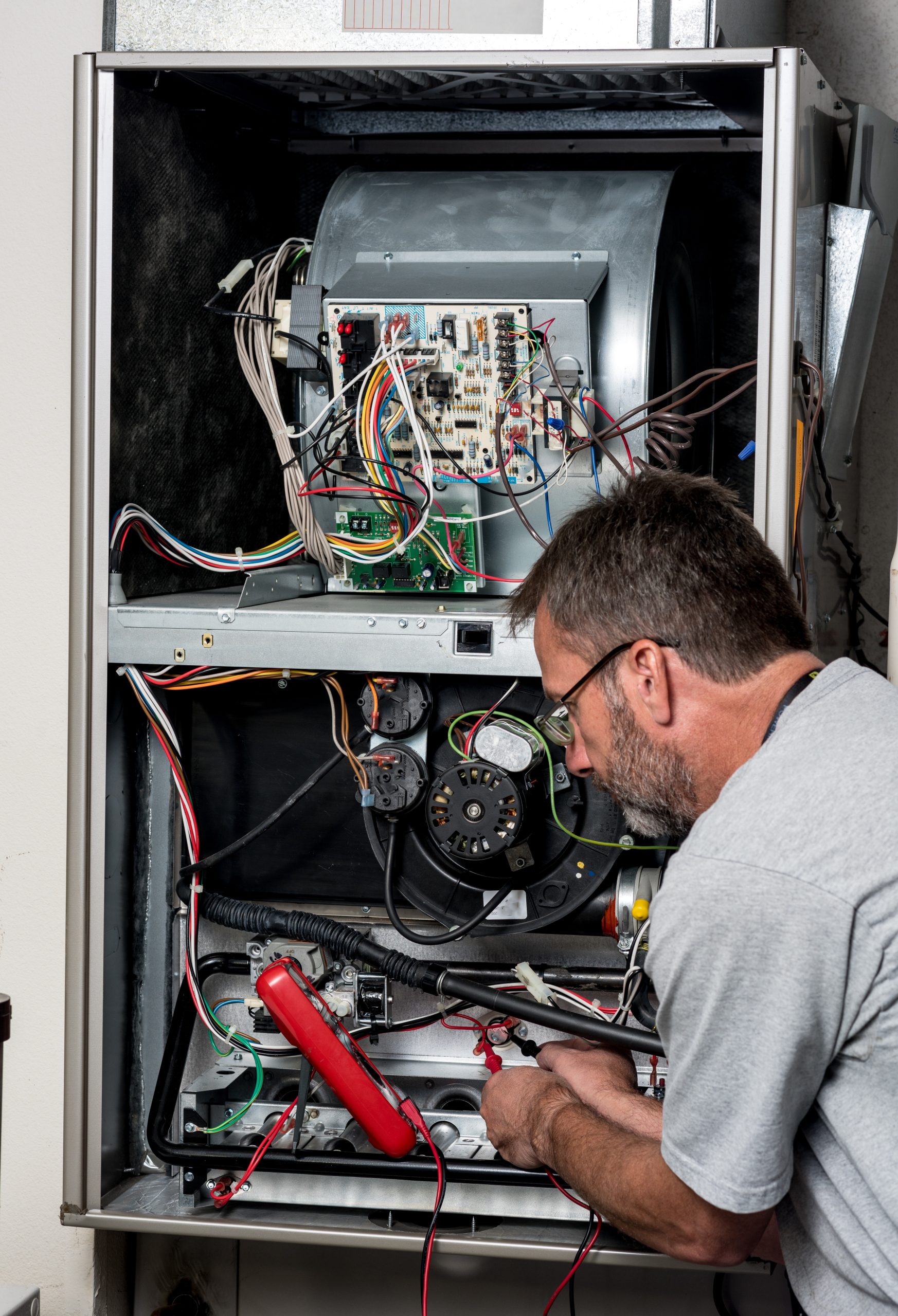 Garnett technician using diagnostic equipment on a furnace in a Spotsylvania home.
